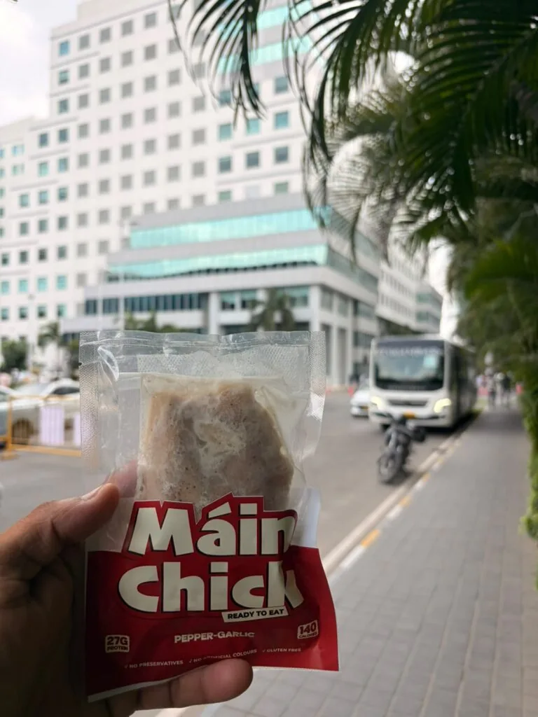 Máin Chick Pepper-Garlic pack held up on a Chennai street
